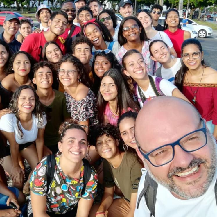 A Jesuit with a group of young ignatian boys and girls